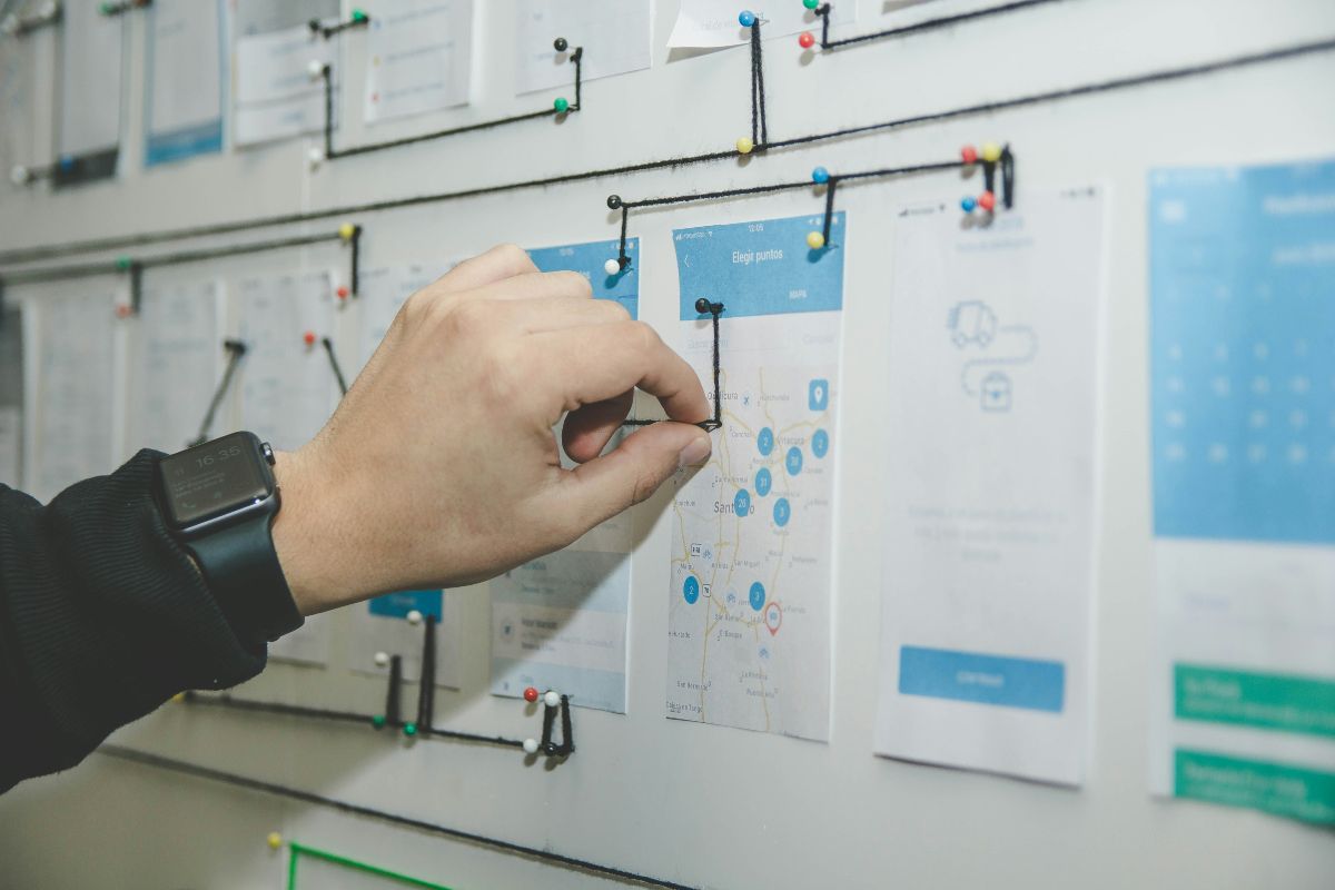 person working on a blue and white paper on board