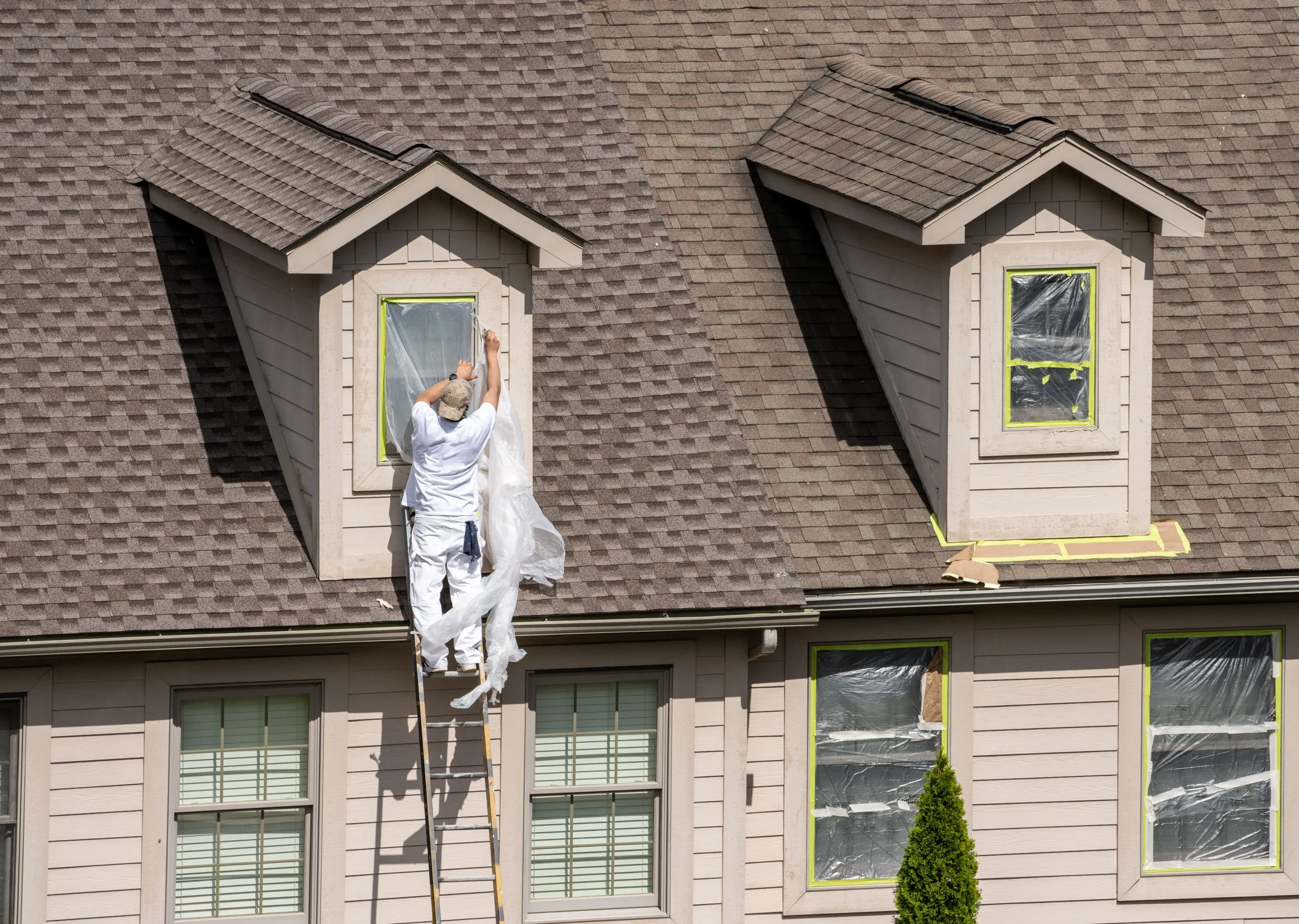 exterior-painting-st-paul-mn-painter-prepping-dormer-windows-on-roof