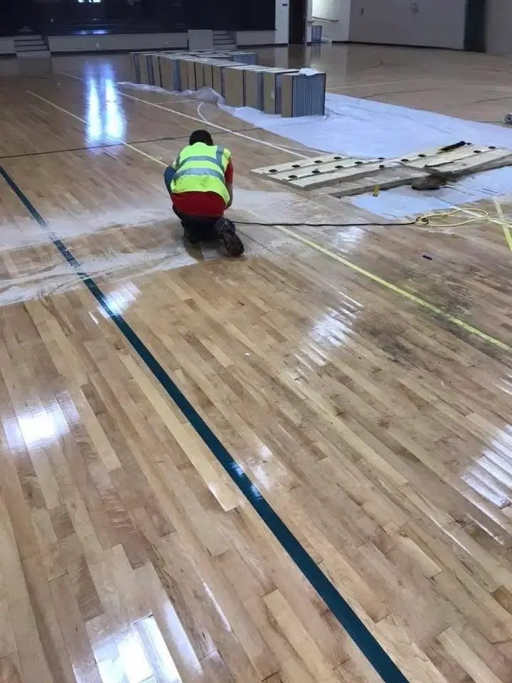 water-damage-repair-st-paul-mn-technician-working-on-flooded-gym-floor
